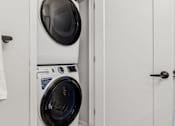 Thumbnail 71 of 99 - A white door is open to a laundry room with a washer and dryer.