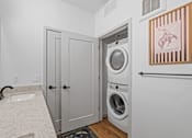 Thumbnail 112 of 113 - A laundry room with a washer and dryer in it.