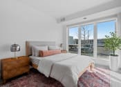 Thumbnail 20 of 103 - a bedroom with a bed and a large window