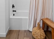Thumbnail 22 of 103 - a bathroom with a shower curtain and a bath tub