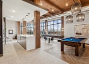 Thumbnail 49 of 103 - A billiard table is in the middle of a room with a pool table.