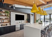 Thumbnail 45 of 99 - A modern kitchen with a white countertop and black cabinets.