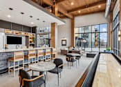 Thumbnail 45 of 103 - A modern kitchen and dining area with a bar and seating.