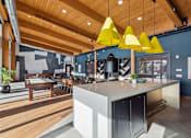 Thumbnail 44 of 99 - A modern kitchen with a wooden ceiling and a white island.