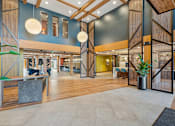 Thumbnail 34 of 99 - A modern interior with wooden floors and a mix of seating areas.