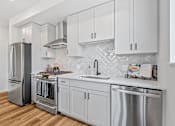 Thumbnail 7 of 99 - a kitchen with white cabinets and stainless steel appliances