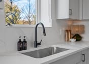 Thumbnail 15 of 103 - a kitchen sink with a window over it