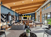 Thumbnail 46 of 99 - A modern living room with a grey sofa and a black coffee table.