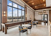 Thumbnail 46 of 103 - A room with a long table and chairs with a view of the outside.