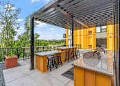 Thumbnail 100 of 103 - A yellow and grey outdoor bar area with a black railing.