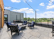 Thumbnail 83 of 103 - A patio with chairs and a table is set up on a balcony.