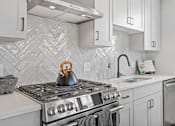 Thumbnail 9 of 99 - a kitchen with a stove and a sink