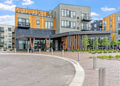 Thumbnail 103 of 103 - A modern building with a circular driveway in front.