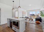 Thumbnail 16 of 103 - an open living room with a kitchen and a living room area with a table