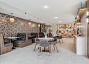 Thumbnail 53 of 103 - A modern dining area with a patterned wallpaper and a mix of wooden and black chairs.