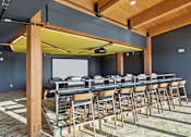 Thumbnail 32 of 99 - A conference room with a long table and chairs.