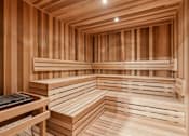 Thumbnail 51 of 103 - A wooden sauna with benches and a table.