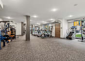 Thumbnail 28 of 103 - A spacious gym with various exercise equipment.