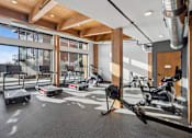 Thumbnail 41 of 99 - A gym with treadmills, exercise bikes and a rowing machine.