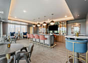 Thumbnail 70 of 103 - A modern dining area with a bar and a television.