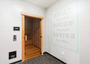 Thumbnail 33 of 103 - A room with a quote on the wall and a wooden door.