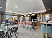 Thumbnail 41 of 103 - A modern dining area with a bar and chairs.
