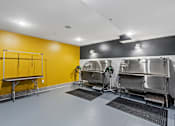 Thumbnail 71 of 103 - A clean, empty industrial kitchen with stainless steel appliances and a yellow wall.