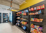 Thumbnail 73 of 103 - A vending machine with a variety of snacks inside.