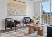 Thumbnail 19 of 103 - a living room with leather furniture and a large window