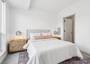 Thumbnail 4 of 103 - A bedroom with a large bed and a wooden chest of drawers.