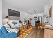 Thumbnail 107 of 113 - A living room with a blue armchair and a white couch.