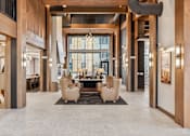 Thumbnail 59 of 103 - A spacious lobby with a large table and chairs.