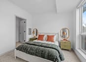 Thumbnail 109 of 113 - A bedroom with a bed, nightstand, and two round mirrors.