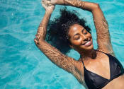 Thumbnail 23 of 103 - a woman swimming in a pool with her hands in the water