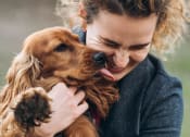 Thumbnail 64 of 103 - a woman holding a dog in her arms
