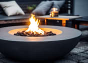 Thumbnail 63 of 103 - a fire pit with a roaring fire on a patio