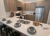 Thumbnail 10 of 33 - Quartz Countertop Kitchen at Foothill Lofts Apartments & Townhomes, Logan, UT, 84341