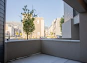 Thumbnail 40 of 75 - A balcony with a view of a street and buildings from Parc on 5th Apartments & Townhomes