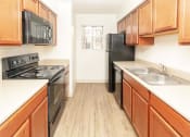 Thumbnail 3 of 24 - Modern Kitchen With Custom Cabinet at Cimarron Place Apartments, Tucson, AZ, 85712