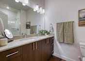 Thumbnail 4 of 20 - Bathroom with Brown Cabinets at Orchard Park Apartments