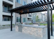 Thumbnail 18 of 61 - Outdoor Kitchen with a Grill and a Pergola at Parc on 5th II American Fork, UT
