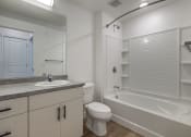 Thumbnail 13 of 14 - Bright bathroom with large tub