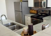 Thumbnail 19 of 40 - Burnett Station Townhome Kitchen Sink With Faucet at Metropolitan Collection Apartments, Renton, Washington