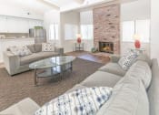 Thumbnail 10 of 15 - Clubhouse Lounge sitting area with a couch, three chairs, coffee table, large rug and decor at Bent Tree Apartments, Sacramento, CA