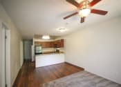 Thumbnail 13 of 24 - Living Room With Kitchen View at Creekside Villas Apartments, San Diego