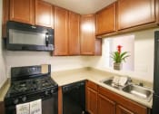 Thumbnail 5 of 24 - Modern Kitchen with Microwave at Creekside Villas Apartments, San Diego, CA