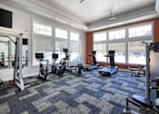 Thumbnail 17 of 32 - A spacious gym with a variety of exercise equipment at the Talavera at the Junction