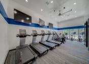 Thumbnail 15 of 21 - Cardio Machines In Gym at Chesapeake Commons Apartments, California, 95670