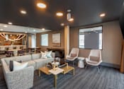 Thumbnail 26 of 42 - Chairs and Couch in Clubhouse at City Lofts Apartments