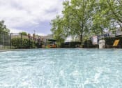 Thumbnail 12 of 21 - Glimmering Pool at Chesapeake Commons Apartments, California